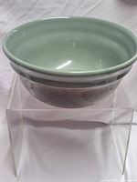 Overall view of green interior and brown exterior stoneware bowl
