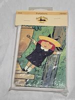 Front view of sealed package showing Madeline witch costume illustration