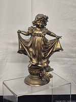Front view of bronze-tone girl figurine