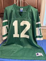 Front view showing number 12, V-neck, sleeve stripes, Champion tag