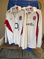 Front view of both England rugby shirts on hangers