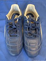 Top view of both navy Puma shoes showing quilting, laces, tongue logo