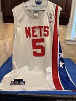 Front view New Jersey Nets #5 jersey showing team name and side stripe