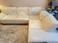 Full view of cream leather sectional sofa assembled