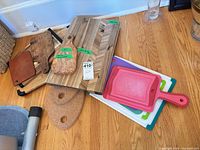 Group of cutting boards, cork trivets and plastic boards on floor