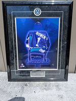 Front view of framed signed photo showing image, signature, matting and frame