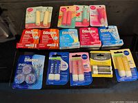 All twelve sealed lip-care packages laid out on table