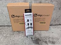 Front view of sealed Digipower cable retail box between two Digipower shipping boxes