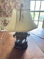 Full lamp with shade on wooden table