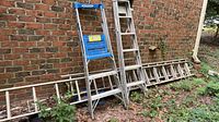 Werner podium ladder, All American extension ladder on ground, Sears ladder section against wall