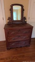 Full view of dresser with attached mirror