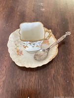 Cup resting on saucer with spoon displayed