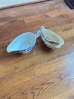 Both gravy boats top view showing interiors and shapes