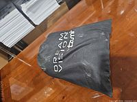 Branded drawstring pouch closed on table