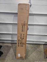 Full view of sealed cardboard box containing hammock stand and sling