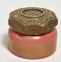 Jar closed showing coral body and ornate gold lid