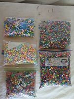 Five bags of assorted pony beads laid out