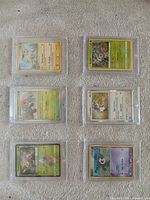 Six Pokémon cards each in magnetic one-touch case