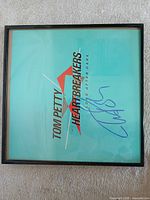 Front view of framed signed album cover insert