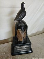 Full view of trophy with bird figure and pedestal
