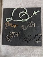 Top view of all five religious jewelry pieces laid out