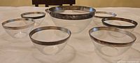 All nine glass bowls arranged on table, showing sterling rims