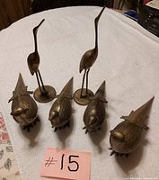 Group shot of all six brass bird figurines