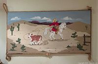 Full view of wall hanging showing entire painted scene and rope frame