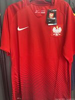Front view of red Nike Poland jersey on hanger showing crest and swoosh