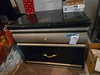 Front view of black and silver two-drawer nightstand