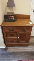 Front view of solid wood cabinet with lamp on top