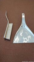 Dustpan and hand brush full view showing design and materials