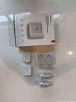 All items laid out: thermostat box, outlet converter, two remotes, two night-lights