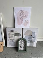 All four pieces: two square abstract canvases, one blush floral line canvas, green arched frame