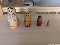 Front view of all four nested dolls arranged by size