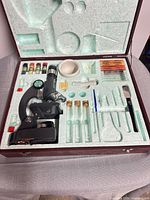 Open case showing microscope and accessories