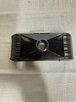 Front view of closed Kodak Jiffy V.P. camera showing lens cover and bakelite body