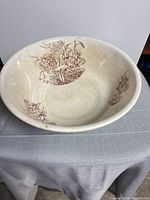 Top view showing brown floral transfer pattern and interior wear