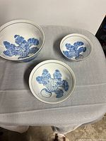 All three bowls nested on table showing size differences and interior design