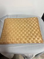 Stack of woven bamboo placemats on table
