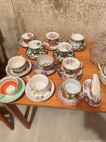 Wide view showing all teacups, saucers, creamer on table