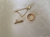 Ring, stick pin and brooch grouped on cloth