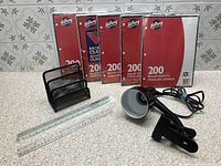 All items displayed together: five Hilroy paper packs, mesh sorter, clip-on lamp, two rulers