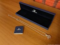 Necklace, presentation box, certificate booklet