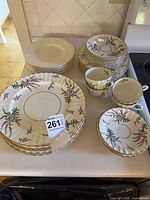 Group view of floral and plain dinnerware stacks on counter