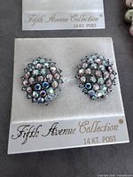 Multicolor rhinestone cluster post earrings on branded card