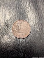 Reverse side showing numeral 5, denomination, year and flag motif