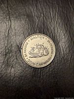 Obverse of Malton Coin Car Wash token showing cartoon car and legends