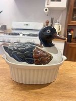 Front view of ceramic casserole with duck lid