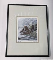 Front view of framed sea otter print showing artwork, mat, and frame